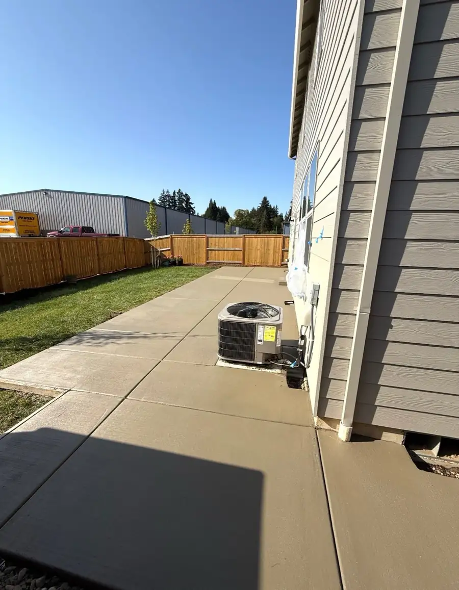 Straight concrete walkway alongside a house